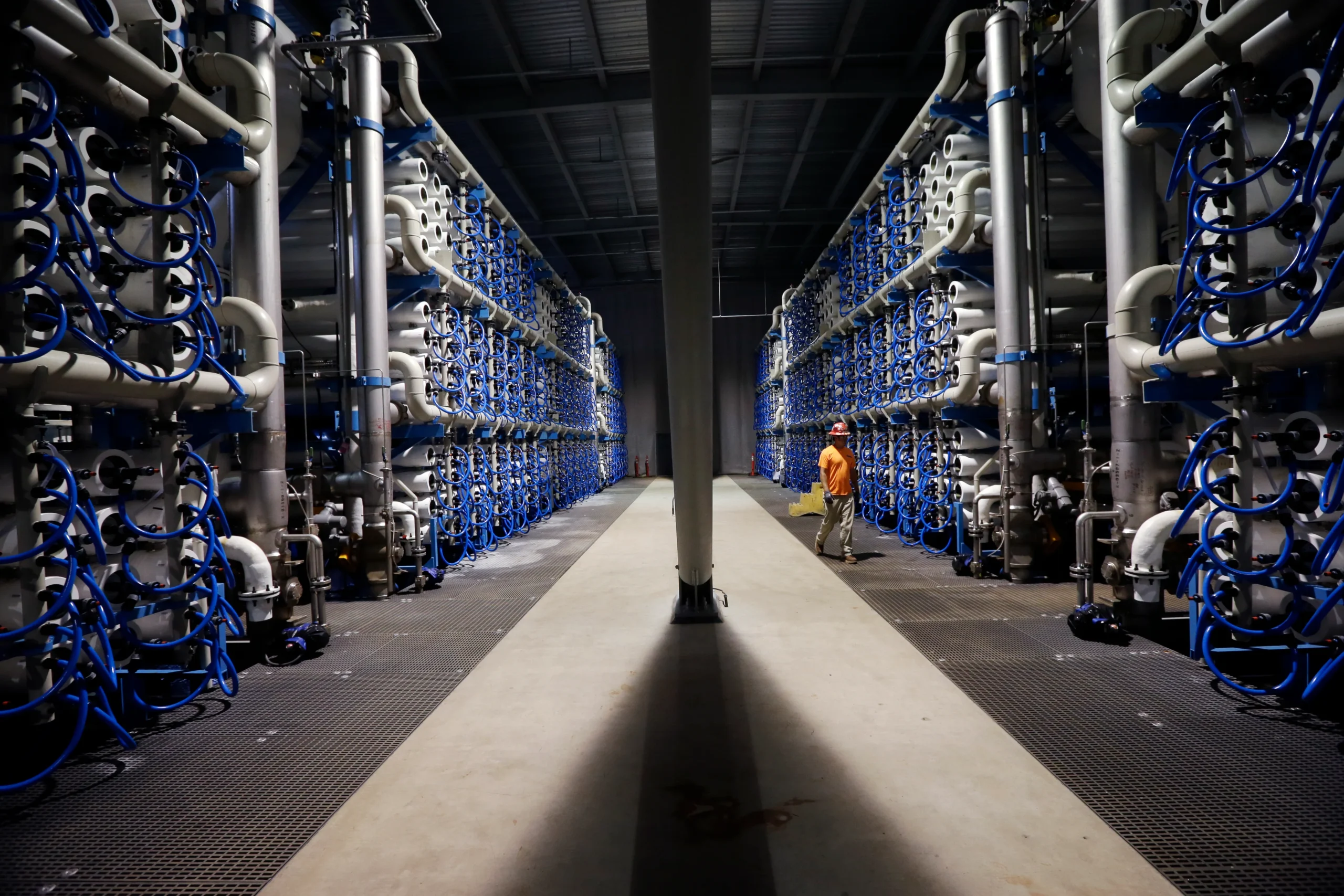 "Customer filling a bottle at a modern water shop in an urban area"